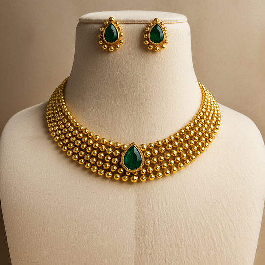 gold necklace and earrings set adorned with vibrant blue stones